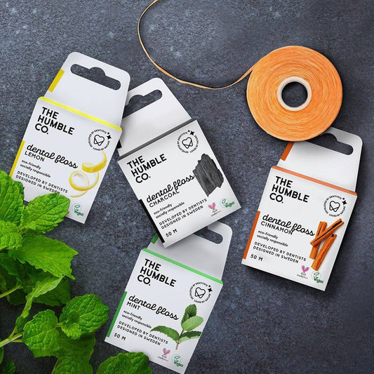 Humble Natural Dental Floss 50 metres in recyclable packaging with lemon, charcoal, cinnamon, and mint flavors for effective, eco-friendly oral care.