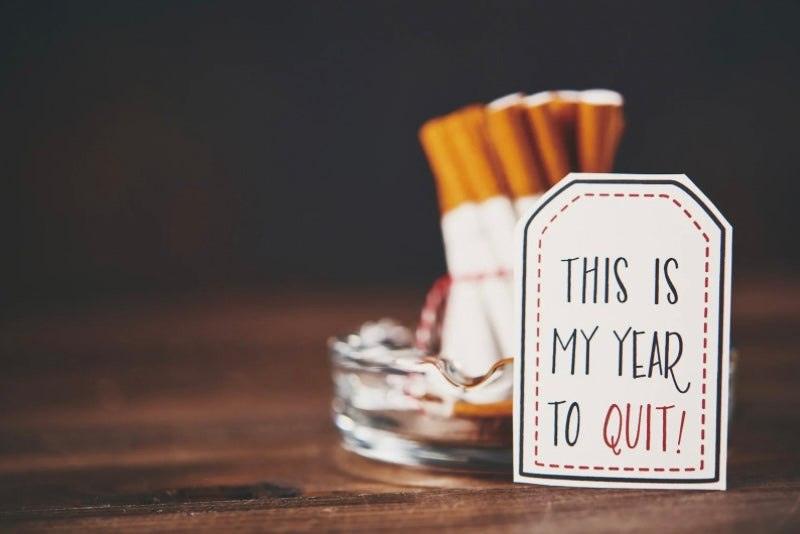 Stoptober quit smoking campaign with cigarettes and motivational card encouraging quitting
