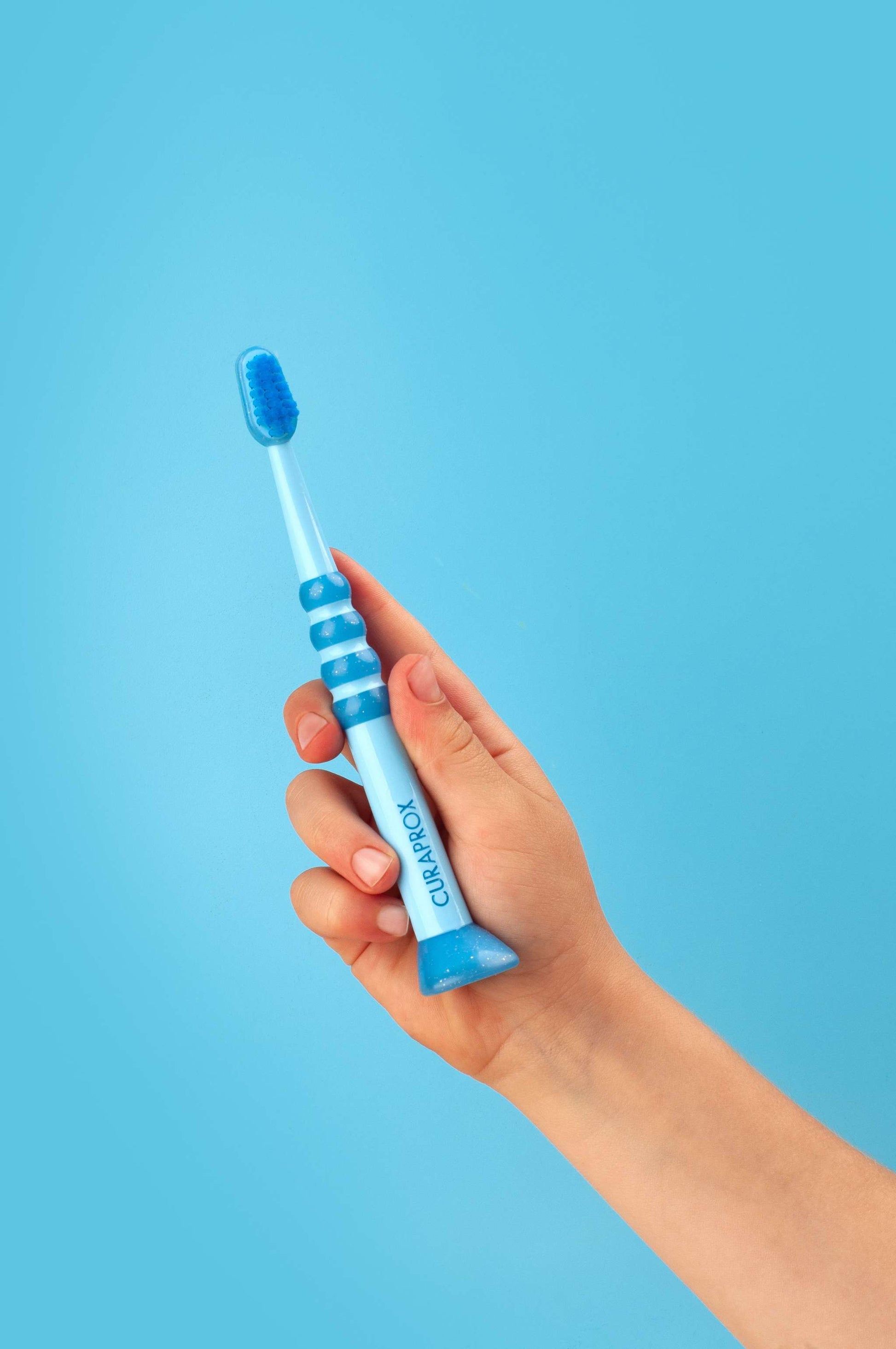 Curaprox Baby Toothbrush for 0-4 years with soft, dense Curen filaments and ergonomic anti-slip handle in blue