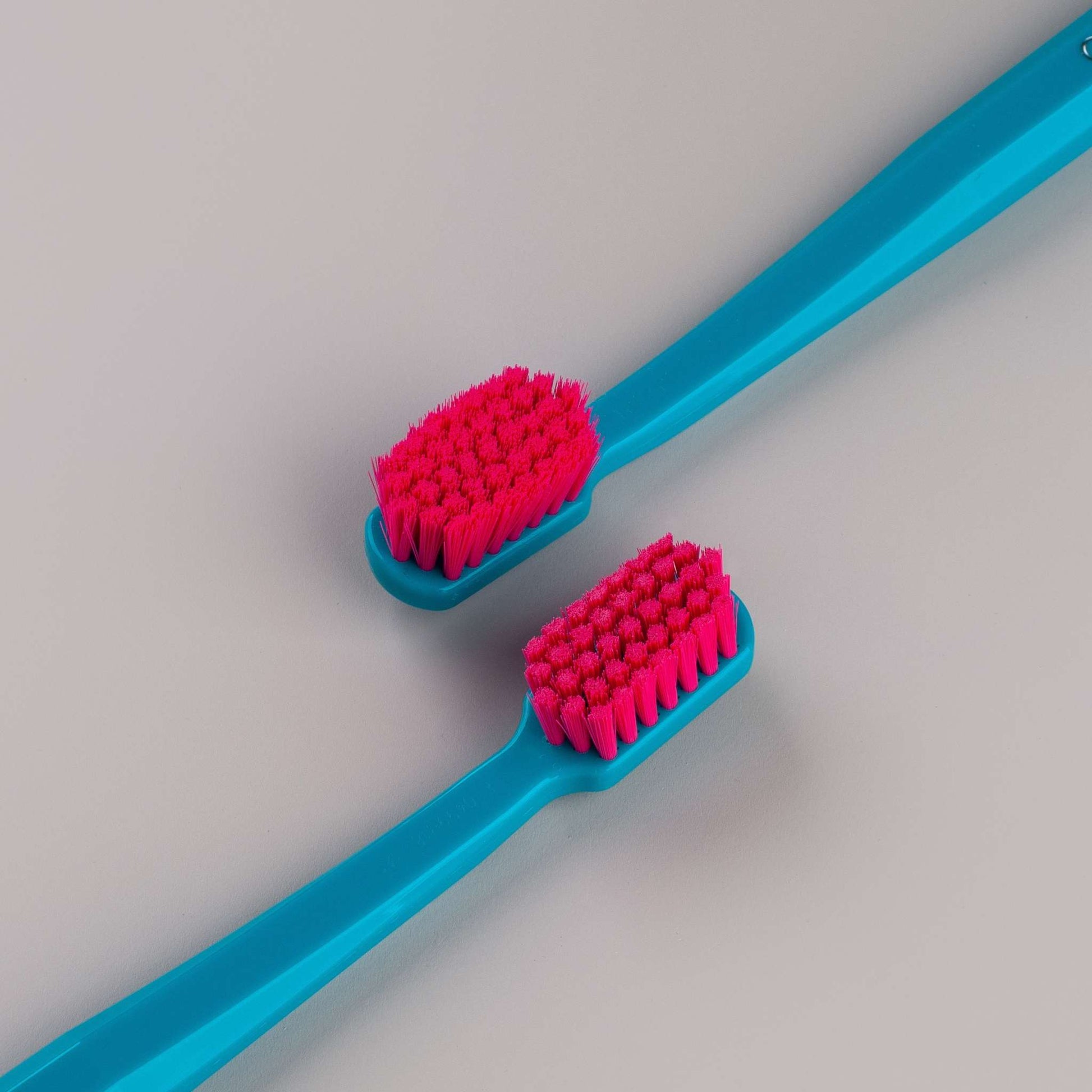 Curaprox CS 5460 ultra soft toothbrush with densely packed red bristles and blue handle for gentle, effective cleaning and plaque removal.