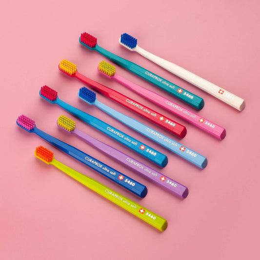 Curaprox CS 5460 ultra soft toothbrushes in assorted colors with dense Curen® filaments for gentle and effective cleaning.