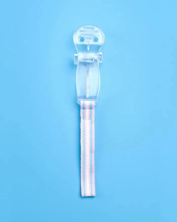 Clear Curaprox Baby Soother Holder with clip and striped fabric strap against blue background