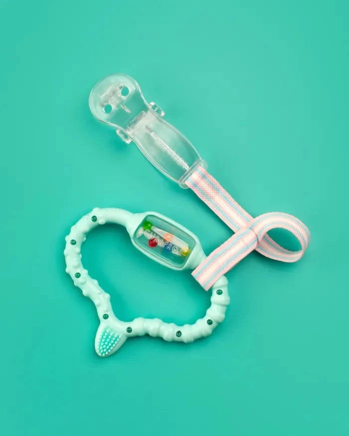 Curaprox Baby Soother Holder clear clip with pastel strap and mint green teething ring on teal background