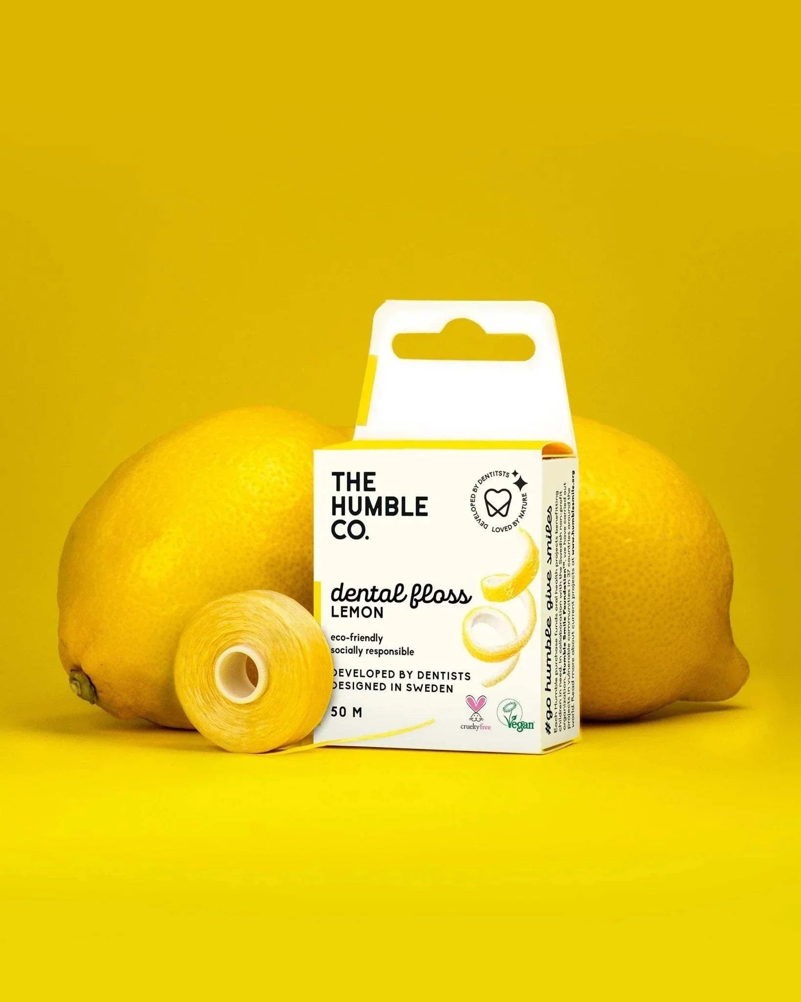 Humble Natural Dental Floss 50 metres lemon flavor eco-friendly recyclable packaging with lemons on yellow background